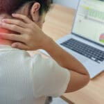 woman having neck and shoulder pain during work long time on wor