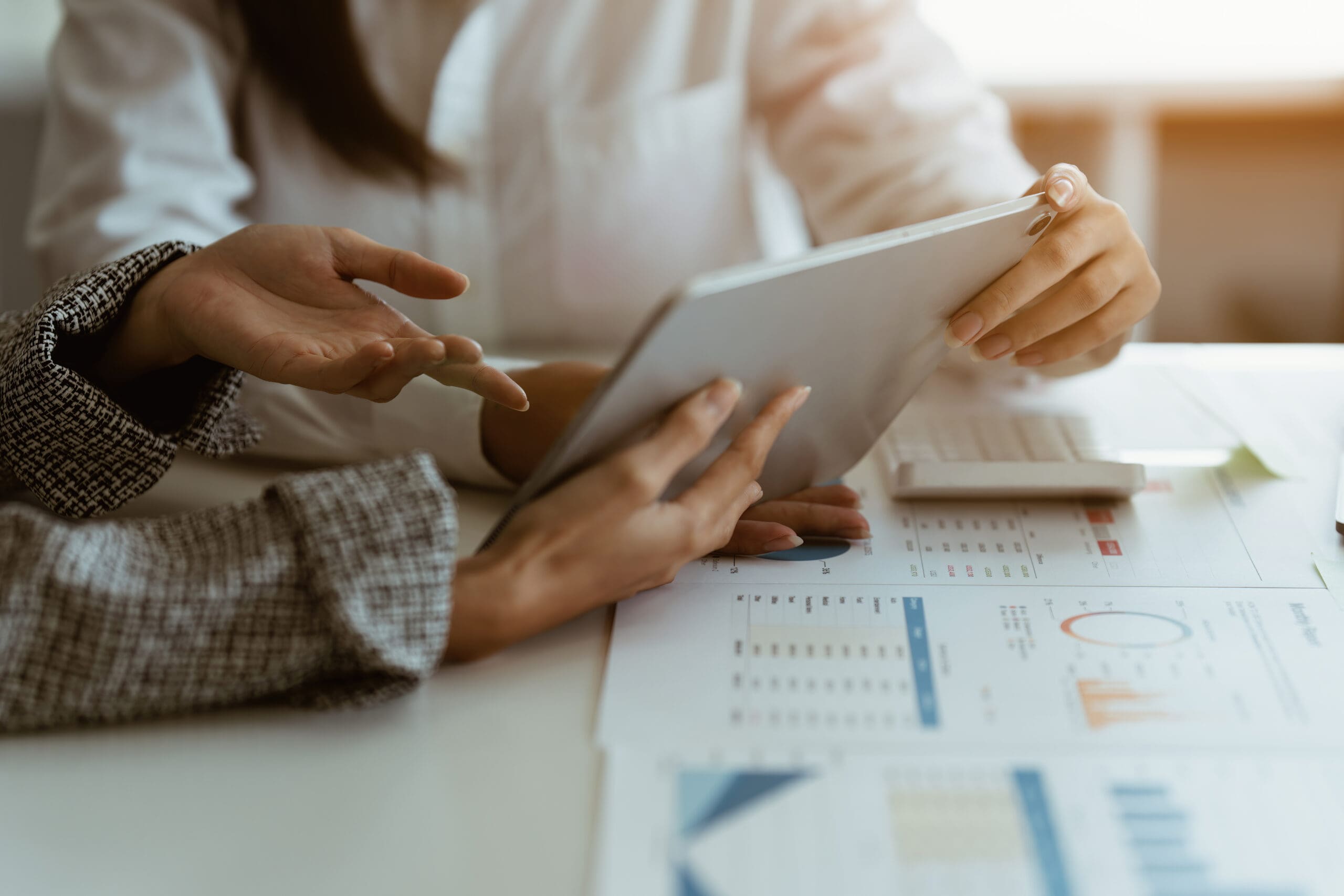 fund managers team consultation and discuss about analysis investment stock market by digital tablet on wooden desk in office.
